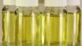 Rotating glass bottles with yellow liquid HD Footage