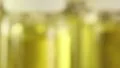 Rotating glass bottles with yellow liquid HD Footage