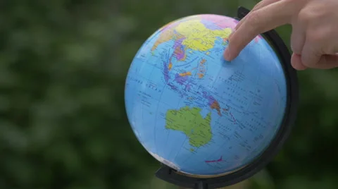 Rotating a Globe with fingers.  Stock Footage 67653686