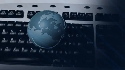 Rotating globe over keyboard, representing global communication and technology Stock Footage 304101987