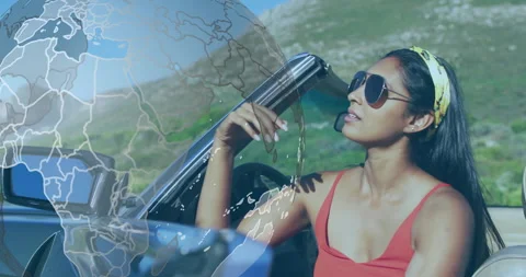 Rotating globe overlay fading triggers female driver gripping wheel and starting Stock Footage 311084058