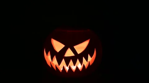 Rotating glowing jack-o-lantern lit from inside Stock Footage 313080204