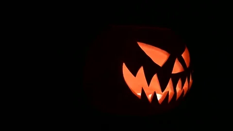 Rotating glowing jack-o-lantern lit from inside Video stock 317981557