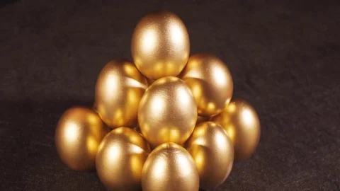 Rotating of golden eggs on black background, closeup shot Stock-Footage 78990681