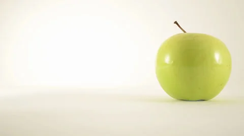 Rotating Granny Smith Apple Against White - Dolly Left Stock Footage 24470939