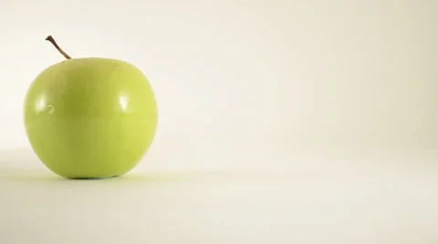 Rotating Granny Smith Apple Against White - Dolly Right Stock Footage 24471001