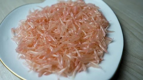 Rotating grapefruit grains view on a white peach plate Stock Footage 282626826