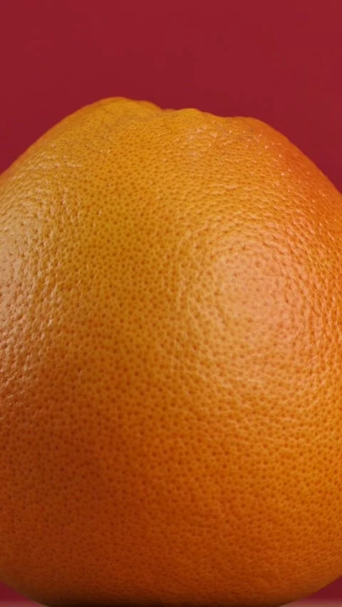 Rotating grapefruit on red background Stock Footage 308046352