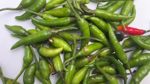 Rotating green chilli isolated on white background, Top view Stock Footage 297490861
