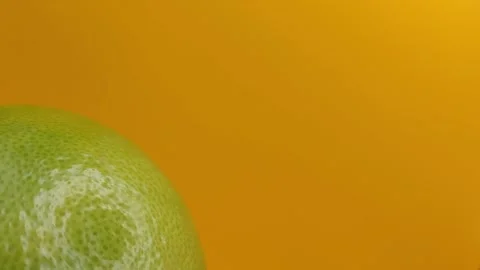 Rotating green grapefruit on a yellow background. Stock Footage 288224240