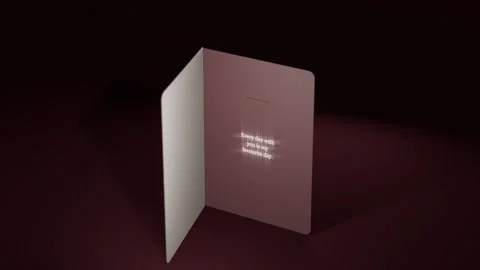 Rotating greeting card on camera shift, opening on maroon table, revealing gold Stock Footage 339721889
