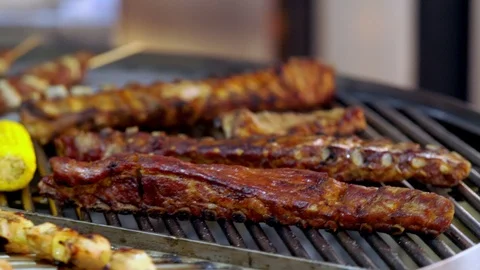Rotating grill packed with assorted kebabs Stock Footage 115079057
