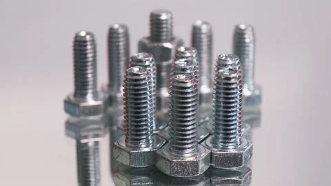Rotating group of galvanized metallic screws close-up. Stainless steel bolts Stock Footage 140819383
