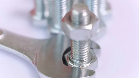 Rotating group of galvanized metallic screws , wrench and nut close-up. Stock Footage 141023260
