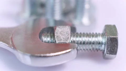 Rotating group of galvanized metallic screws , wrench and nut close-up. Stock Footage 141187362