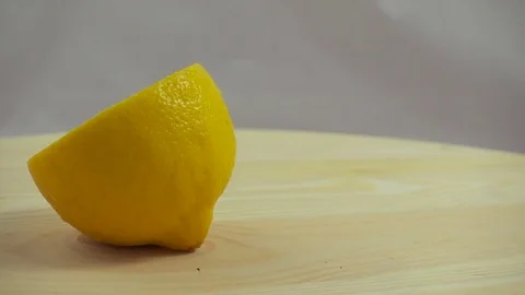 Rotating Half Lemon on a Woody Surface Stock Footage 75514532
