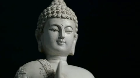 Rotating head of Buddha statue, against isolated black background (loop) Stock Footage 65489504