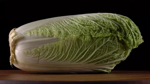 Rotating head of lettuce close up on black background Video stock 162172113