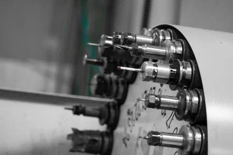Rotating head with tools at CNC lathe in workshop Stock Photos