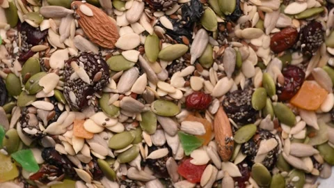 Rotating Healthy Trail Mix Background Top View with Nuts Seeds and Dried Fruits Stock Footage 340747159