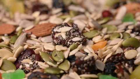 Rotating Healthy Trail Mix Macro Angled Top View with Seeds Nuts &amp; Dried Fruits Stock Footage 340749951