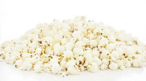 Rotating heap of popcorn, white seamless background Stock Footage 40098098