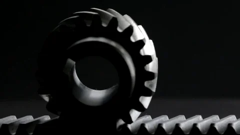 Rotating helical gear rack and a pinion on black background Stock Footage 83633745