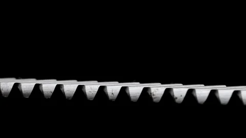 Rotating helical gear rack on black background Stock Footage 83630348