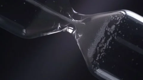 Rotating hourglass close-up on a black background. Time concept. Stock Footage 130329022