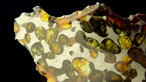 Rotating Of An Iron Meteorite. black background on a mirror base. Close-up. M 스톡 동영상 231556848