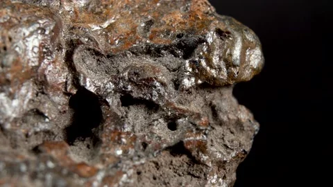 Rotating Of An Iron Meteorite. black background on a mirror base. general pla Vidéo 231559006