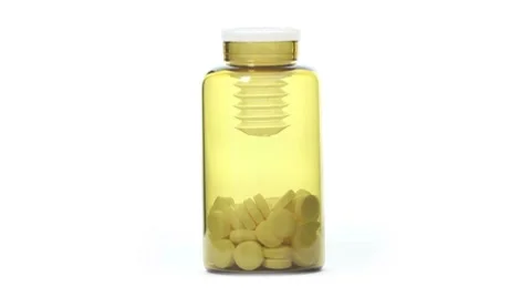 Rotating jar of pills on white background. closeup Stock Footage 8657562