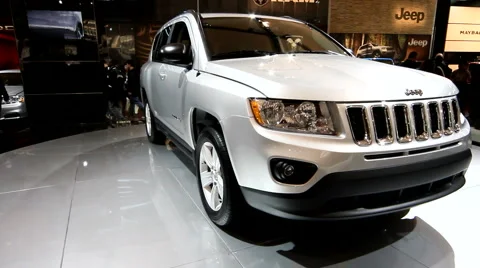 Rotating Jeep grand cherokee on display at the auto show Stock Footage 1096887