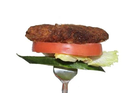 Rotating kebab in fork Stock Photos