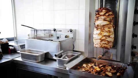 Rotating kebab meat in a heating device ready to be served. Appetite chicken Stock Footage 281248086