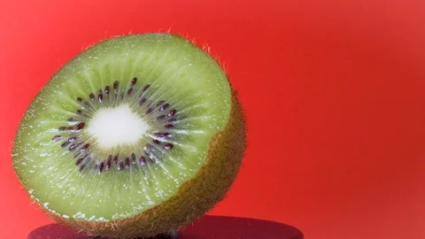 Rotating Kiwi Close Up on a Red Background 스톡 동영상 113404820