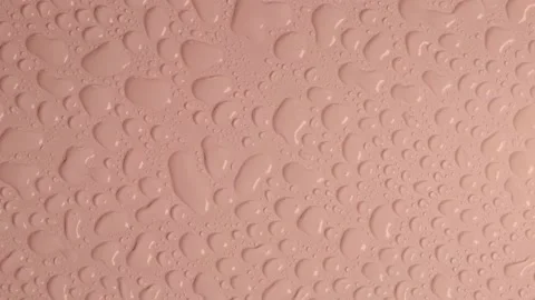 Rotating light beige pastel background with water drops or transparent cosmetic Stock Footage 212111952