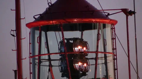 Rotating lighthouse at dusk in harbor Stock Footage 38736231