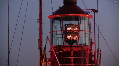 Rotating lighthouse at dusk in harbor Stock Footage 39040297