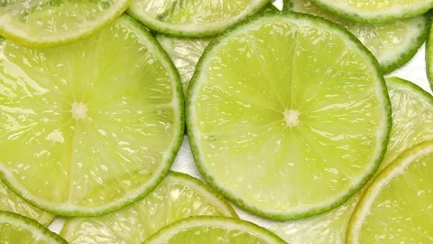 Rotating lime slices top view in seamless circular motion, fresh citrus fruit Stock Footage 305923280