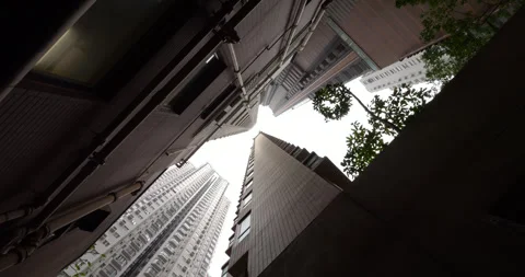 Rotating low angle view of typical towering residential buildings in Hong Kong Stock Footage 309361362