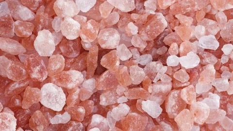 Rotating macro footage of Himalayan salt with falling down on table. Stock Footage 131171427
