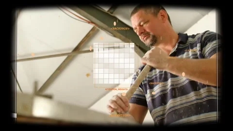 Rotating man in striped polo scraping long wooden rod at workshop bench, with Stock Footage 331713647