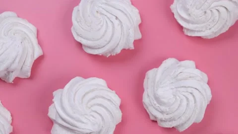 Rotating  marshmallows or cakes, birthday cakes on a pink background Stock Footage 201348928