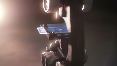 Rotating microscope. A children's toy microscope rotates in a dark mysterious Stock Footage 151590335