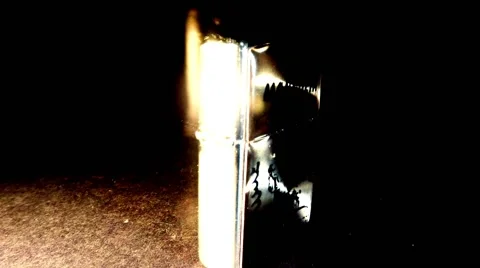 Rotating Mongolian Iron Lighter Close up in the Dark Stock Footage 62636624
