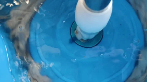 Rotating a mop in a light blue mop container filled with water Video stock 304074637