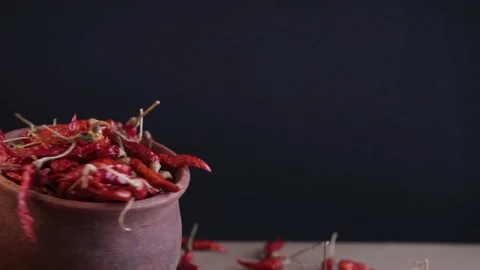 A rotating mud pot filled with red chilli Stock Footage 212788281