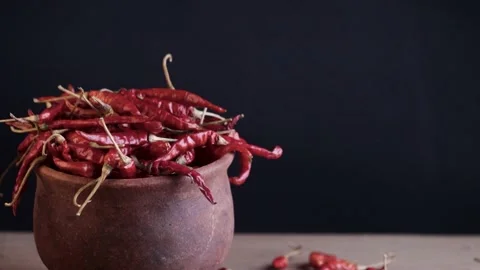 Rotating mud pot filled with red chilli Stock Footage 212788334