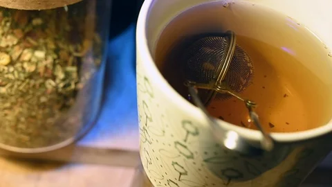 Rotating mug with herbs tea diffuser and tea jar Stock Footage 104874634